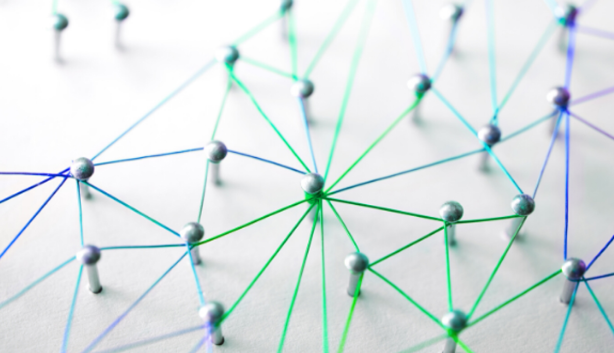 Network of connected blue and green lines with circles at intersections on white background