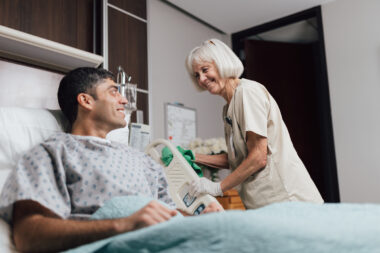 Crothall EVS professional engages with hospital patient