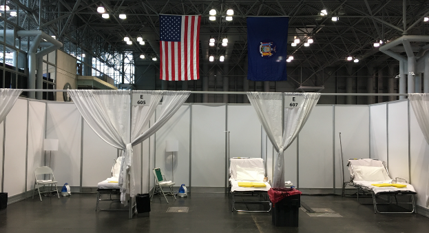 Hospital beds underneath the American flag at the Javits Center