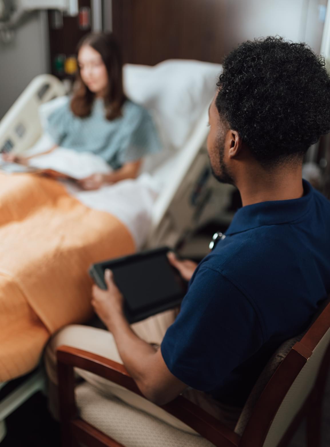 Man attending counseling session with therapist, discussing concerns while seated on couch.