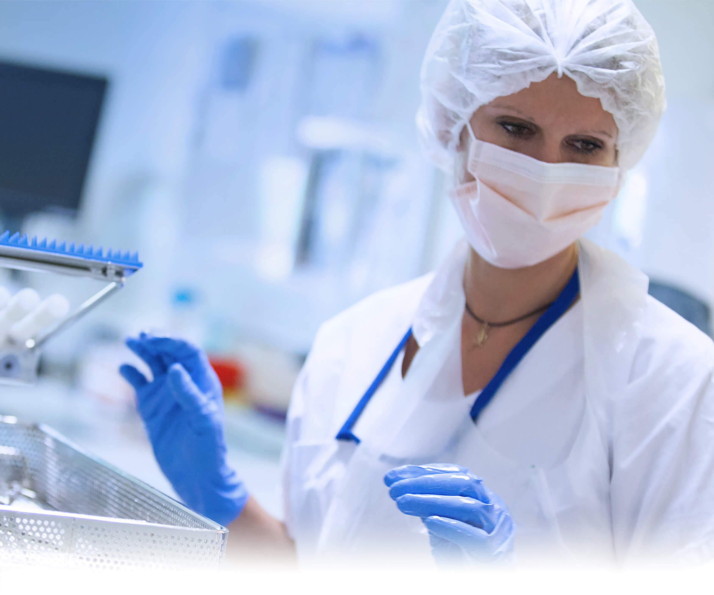 Focused laboratory technician working with medical samples while wearing protective equipment