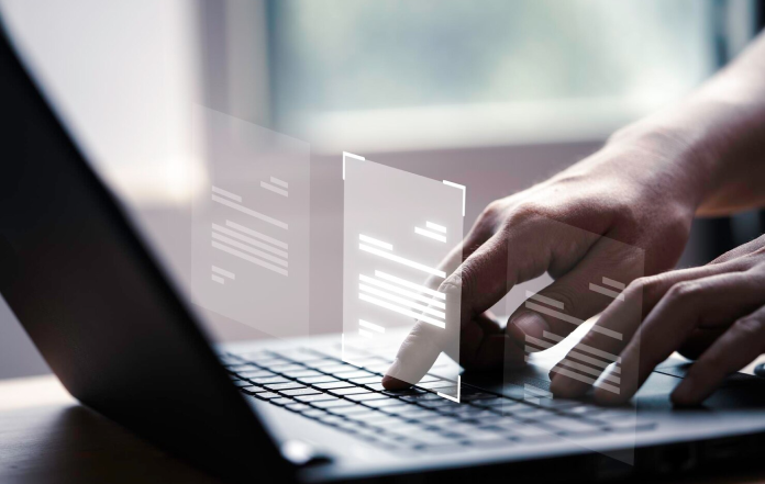 Hands typing on laptop keyboard, digital transparent screens hovering, healthcare IT solutions