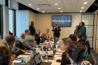 Business meeting with diverse attendees around conference table with 